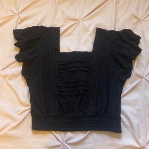 Black medium crop top. Fitted at the waist. Flowy sleeves